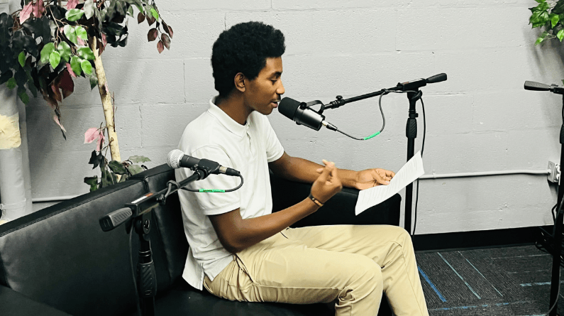 Student talking into microphone